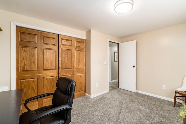 office with baseboards and light colored carpet