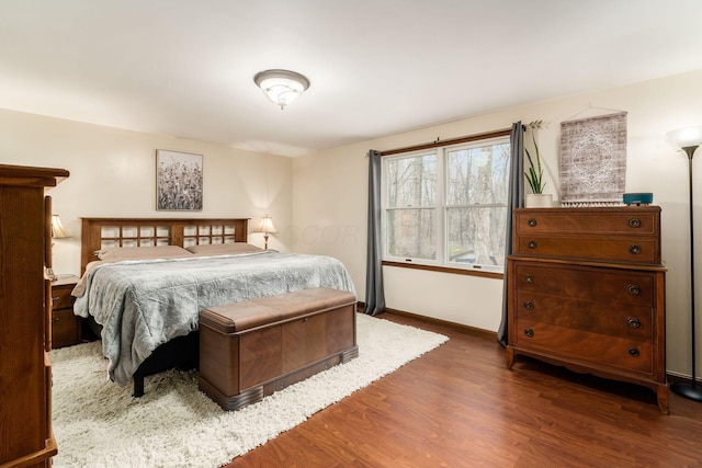 bedroom featuring wood finished floors and baseboards