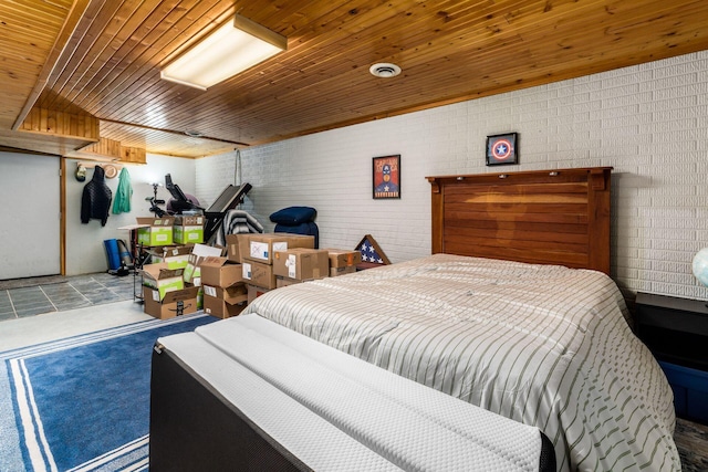 bedroom featuring brick wall and wood ceiling