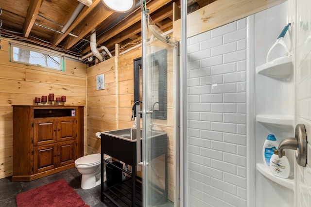 bathroom featuring a shower stall, wooden walls, and toilet