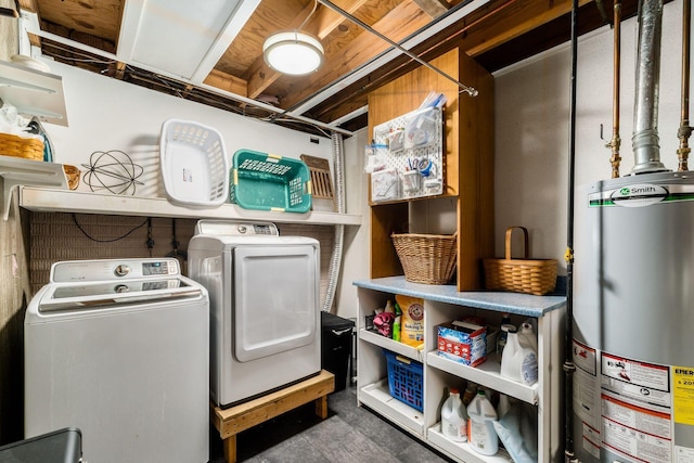 clothes washing area with gas water heater, separate washer and dryer, and laundry area