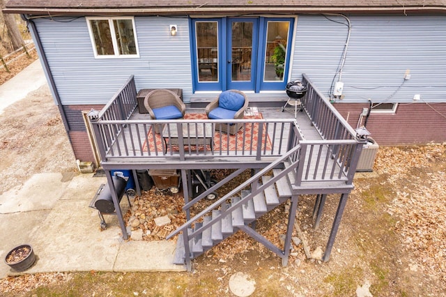 wooden terrace with stairway and an outdoor hangout area