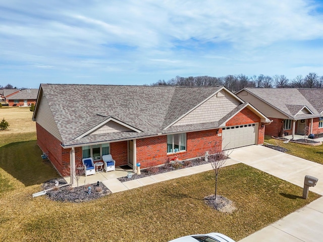 ranch-style house featuring driveway, brick siding, an attached garage, covered porch, and a front yard