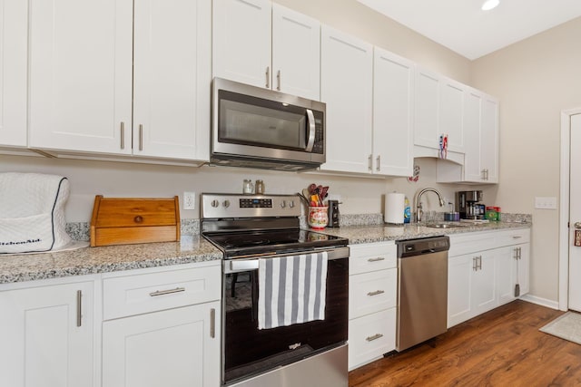 820 Timbers Edge, Marysville, OH 43040 - kitchen featuring appliances with stainless steel finishes, dark wood-style flooring, white cabinets, and a sink