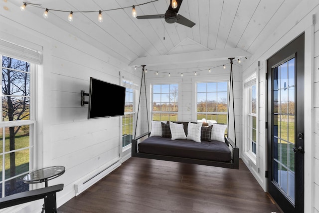 unfurnished sunroom with lofted ceiling, a baseboard radiator, wood ceiling, ceiling fan, and track lighting