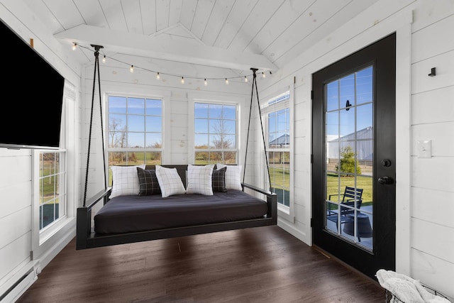 unfurnished sunroom featuring wooden ceiling, a baseboard radiator, and plenty of natural light