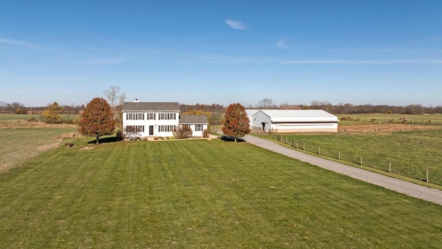 exterior space with a front yard and a rural view