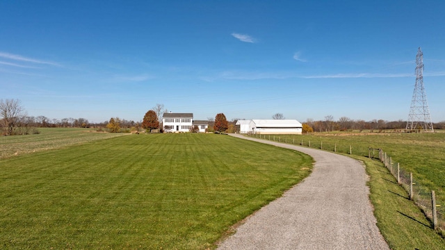 view of yard with gravel driveway and a rural view