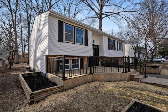 raised ranch featuring a garden and a wooden deck