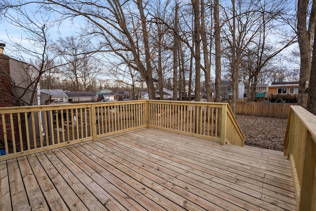 wooden terrace featuring fence