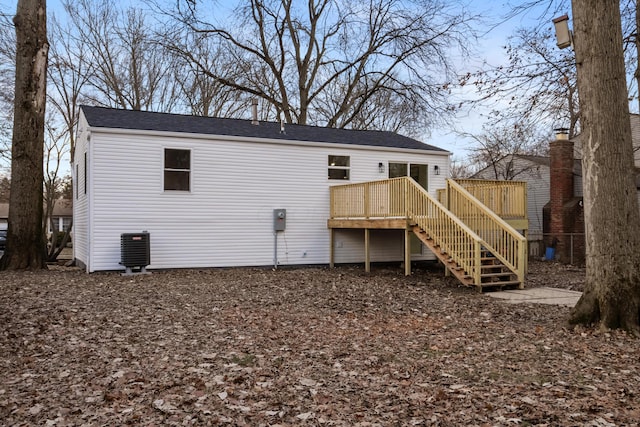 rear view of house featuring a deck and stairway