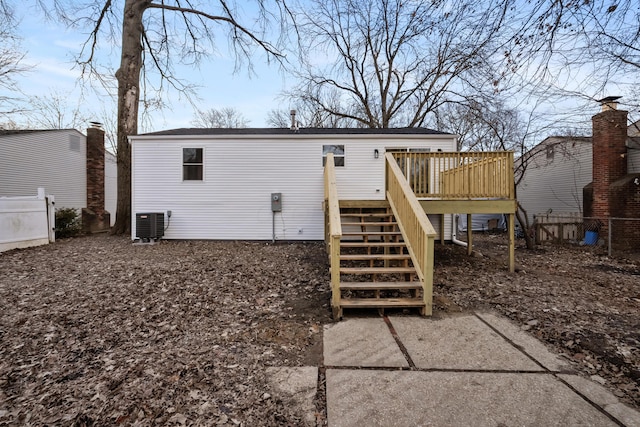 rear view of property with stairs, a deck, cooling unit, and fence