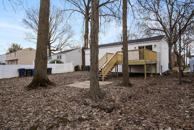 view of yard featuring central air condition unit, fence, a deck, and stairs