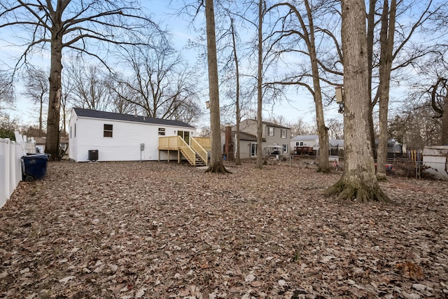 rear view of house featuring fence