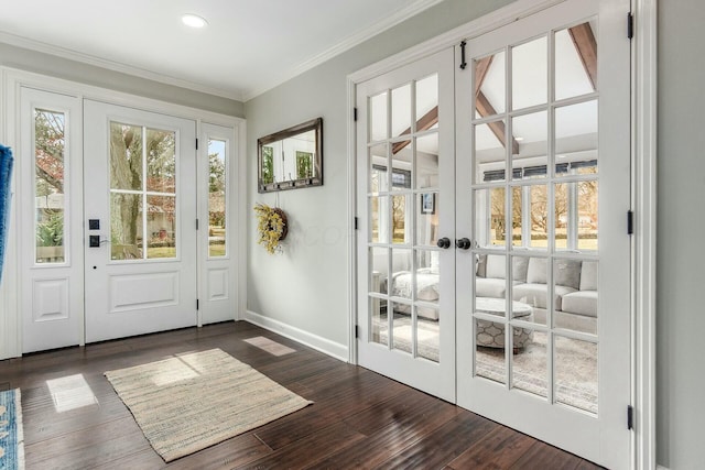 doorway with french doors, crown molding, baseboards, and dark wood-style flooring