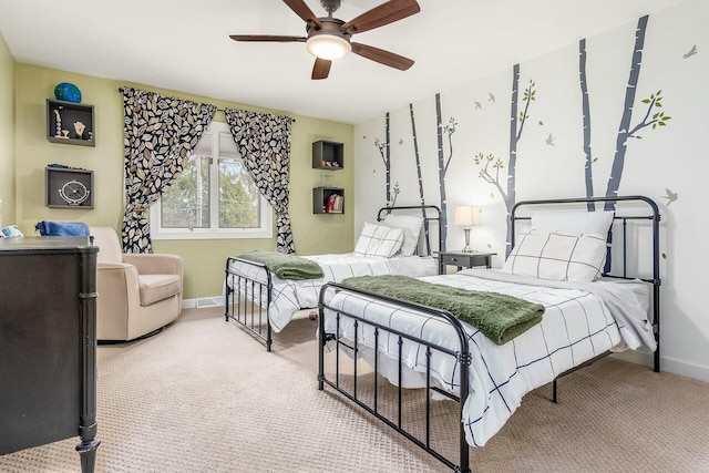 carpeted bedroom featuring ceiling fan and baseboards