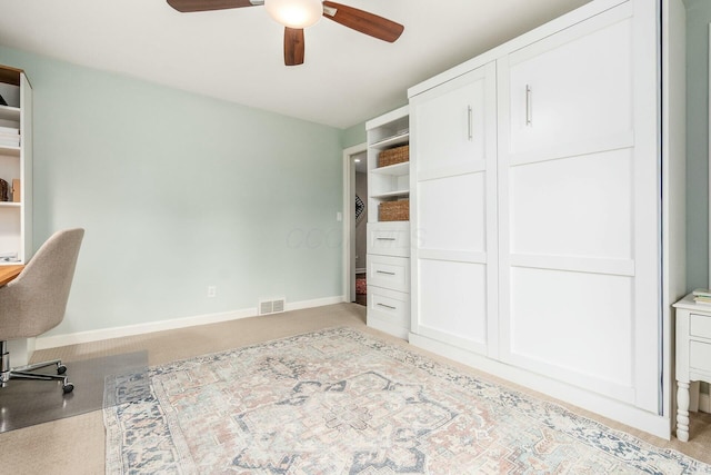 office space featuring visible vents, baseboards, and ceiling fan