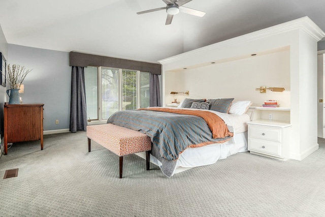 bedroom with visible vents, baseboards, light colored carpet, and vaulted ceiling