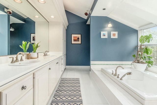 full bath with double vanity, a sink, vaulted ceiling, a garden tub, and tile patterned floors