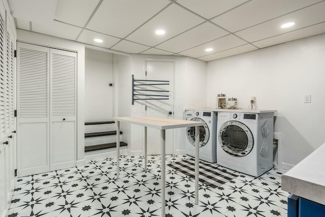 laundry area with laundry area, recessed lighting, washing machine and dryer, and light floors