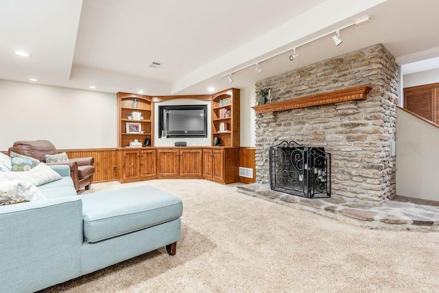 carpeted living room with visible vents, recessed lighting, and a fireplace