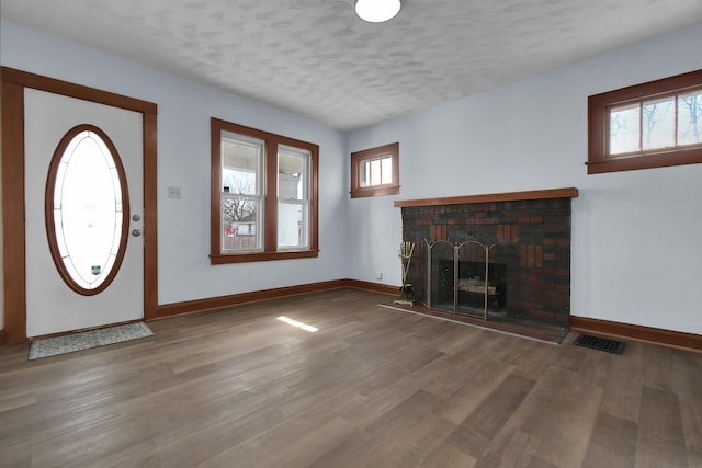 879 Mansfield Ave, Columbus, OH 43219 - foyer featuring a healthy amount of sunlight, visible vents, baseboards, and wood finished floors