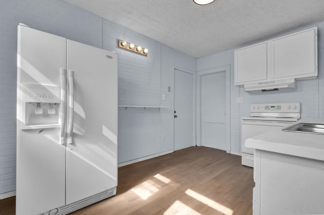 879 Mansfield Ave, Columbus, OH 43219 - kitchen featuring white appliances, white cabinets, wood finished floors, light countertops, and under cabinet range hood