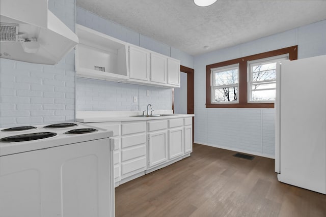 879 Mansfield Ave, Columbus, OH 43219 - kitchen featuring white appliances, visible vents, white cabinets, range hood, and open shelves