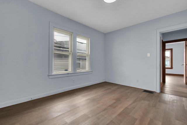 879 Mansfield Ave, Columbus, OH 43219 - unfurnished room featuring visible vents, baseboards, and wood finished floors