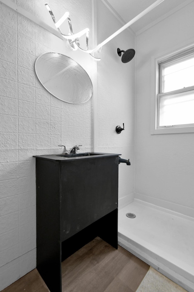 879 Mansfield Ave, Columbus, OH 43219 - bathroom with wood finished floors, walk in shower, and vanity