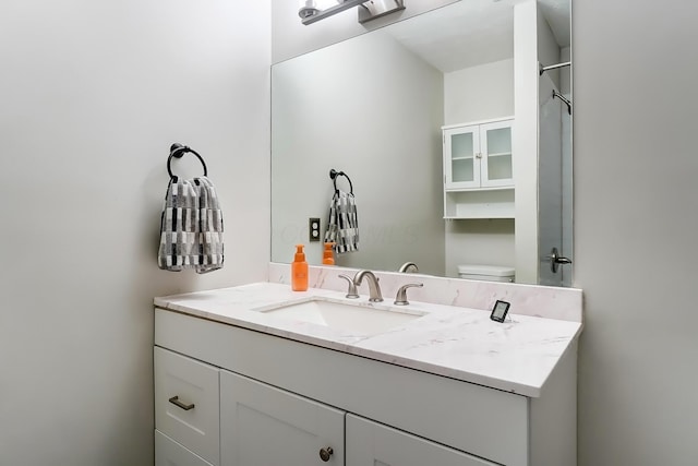 bathroom with toilet and vanity