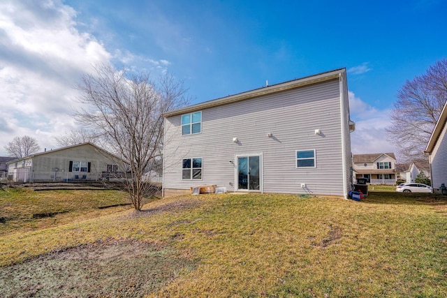 rear view of house with a yard