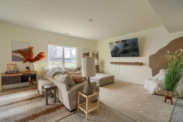 living room featuring carpet and baseboards