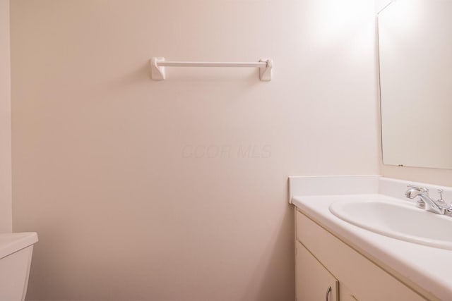 bathroom featuring toilet and vanity