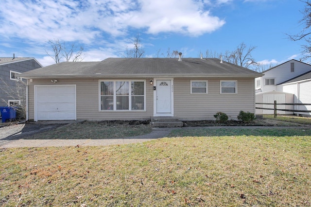 ranch-style house featuring a front yard, fence, and an attached garage