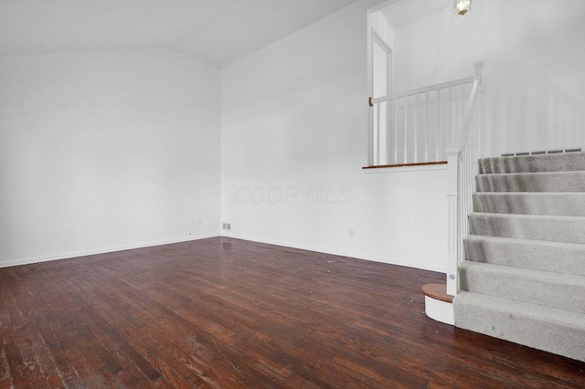 interior space featuring hardwood / wood-style flooring, vaulted ceiling, and stairs