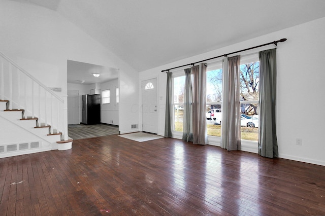 unfurnished living room featuring high vaulted ceiling, wood-type flooring, visible vents, and stairs