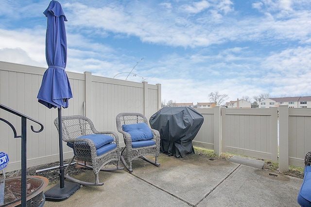 view of patio with fence and area for grilling