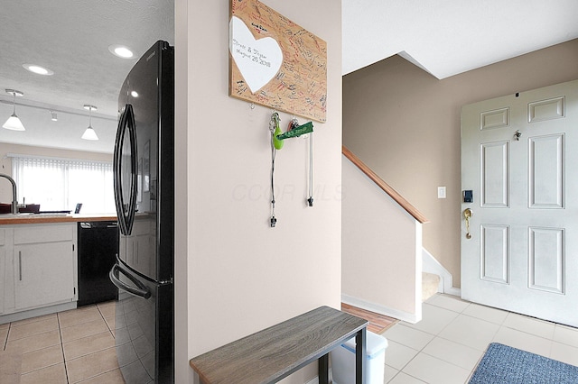 entrance foyer featuring recessed lighting, stairway, light tile patterned flooring, and baseboards