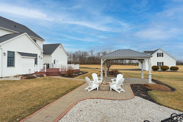 view of patio featuring an outdoor fire pit, a wooden deck, and a gazebo