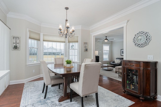 dining area featuring dark wood-style floors, baseboards, a fireplace, and ornamental molding