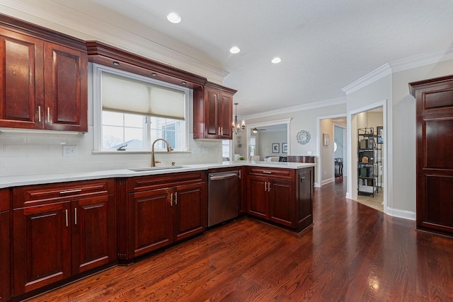 kitchen featuring dark wood finished floors, light countertops, a sink, dishwasher, and a peninsula