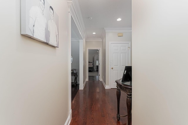 corridor with baseboards, ornamental molding, wood finished floors, and recessed lighting