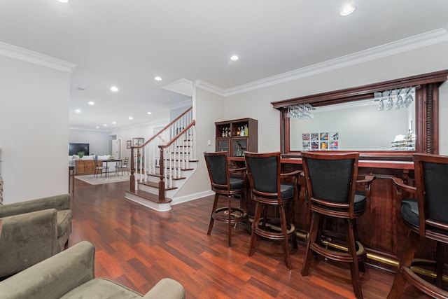 bar with a dry bar, ornamental molding, wood finished floors, stairs, and recessed lighting