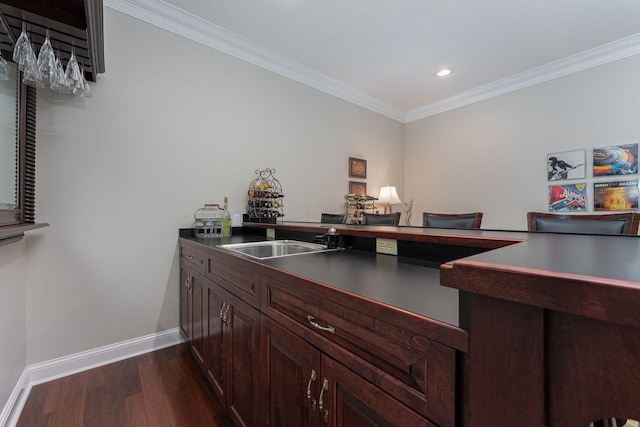 office with recessed lighting, dark wood-type flooring, ornamental molding, a sink, and baseboards