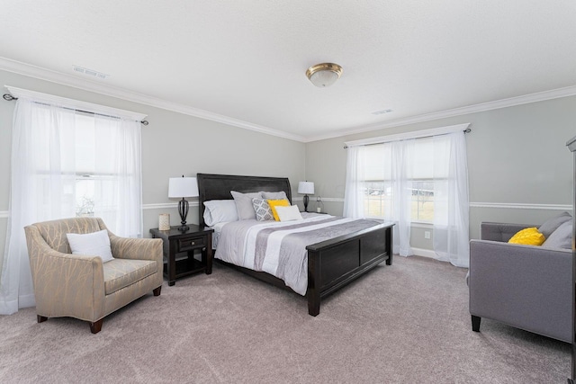 carpeted bedroom featuring ornamental molding and visible vents