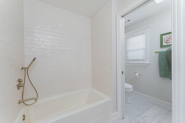 bathroom featuring visible vents, baseboards, toilet, tile patterned flooring, and shower / washtub combination