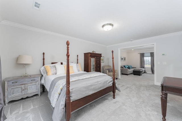 carpeted bedroom featuring ornamental molding, visible vents, and baseboards