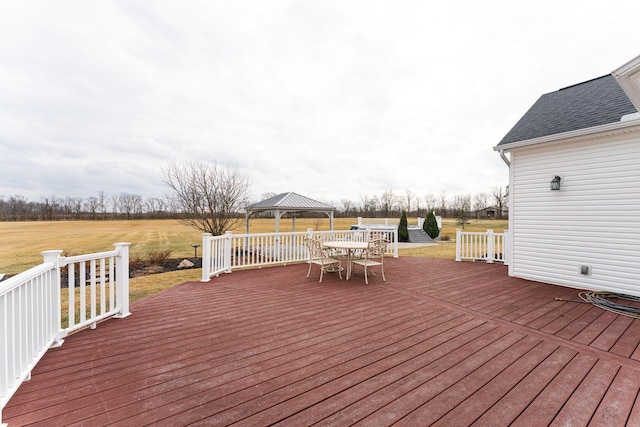 wooden terrace featuring a lawn and a gazebo