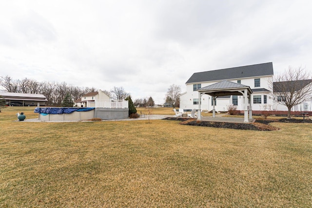 view of yard featuring a covered pool and a gazebo